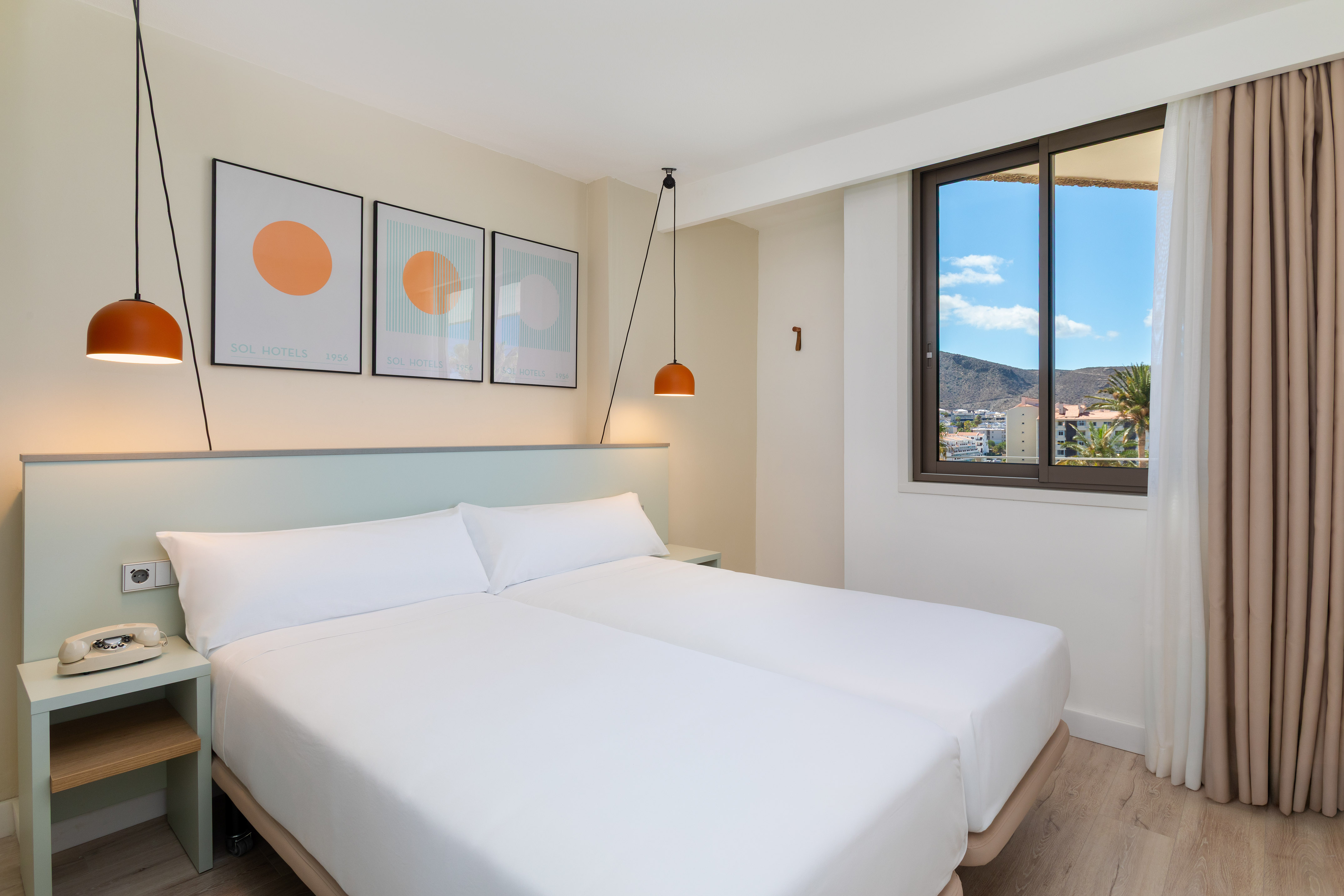 a bed with white sheets and a lamp