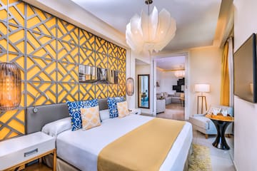 a bedroom with a bed and a lamp