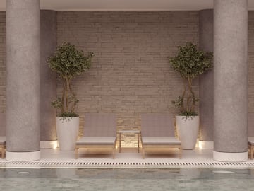 a pool with two chairs and trees