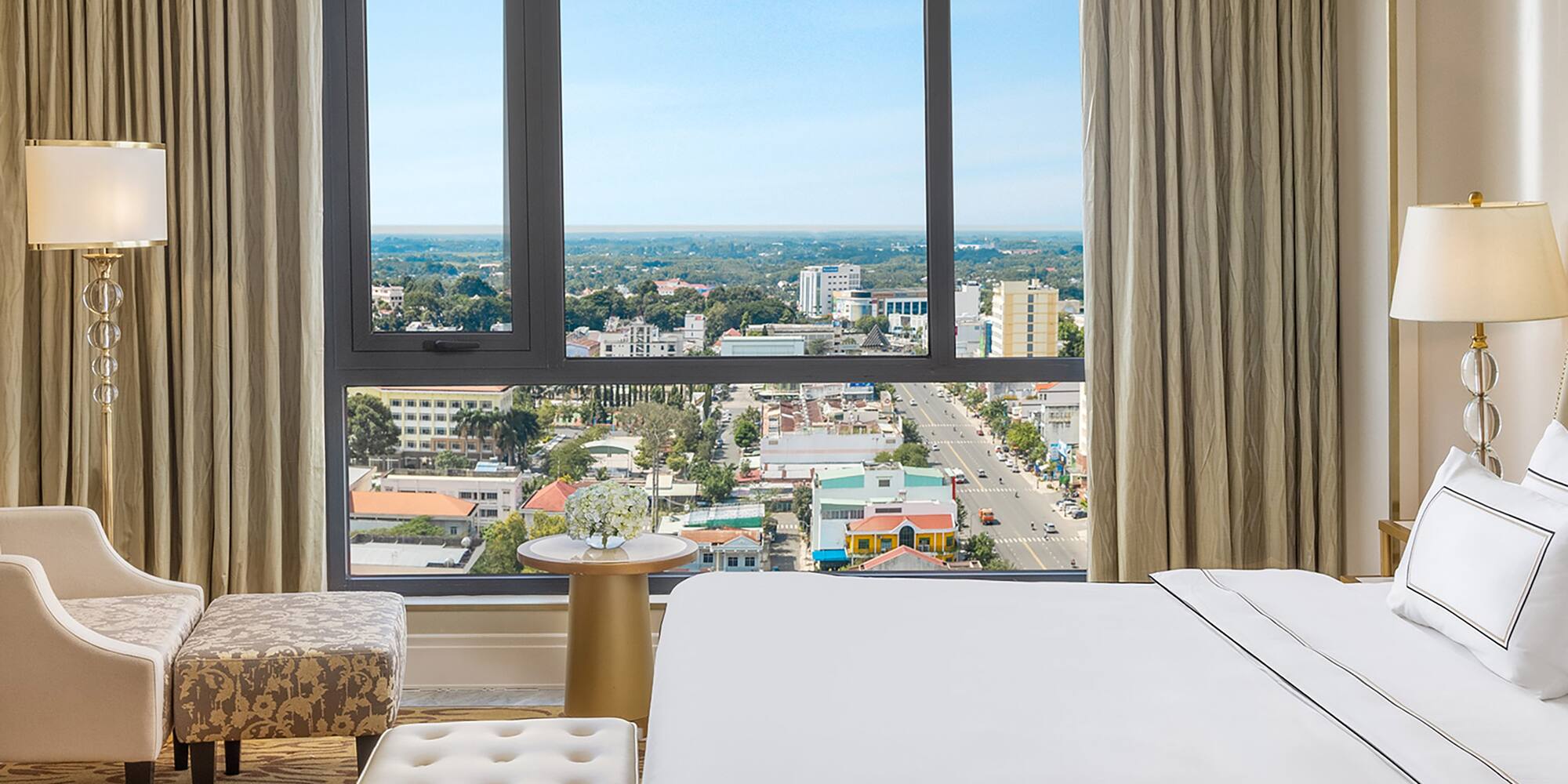 a bedroom with a large window and a large bed