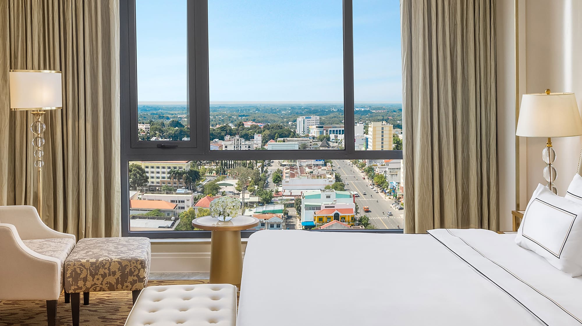 a bedroom with a large window and a large bed