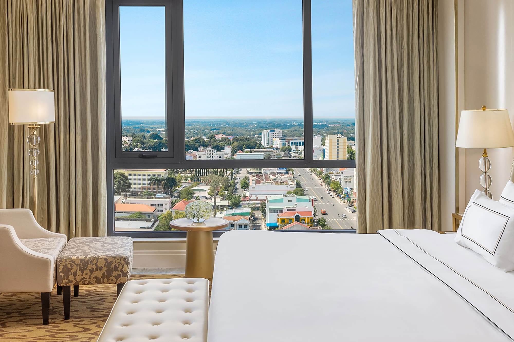 a bedroom with a large window and a large bed