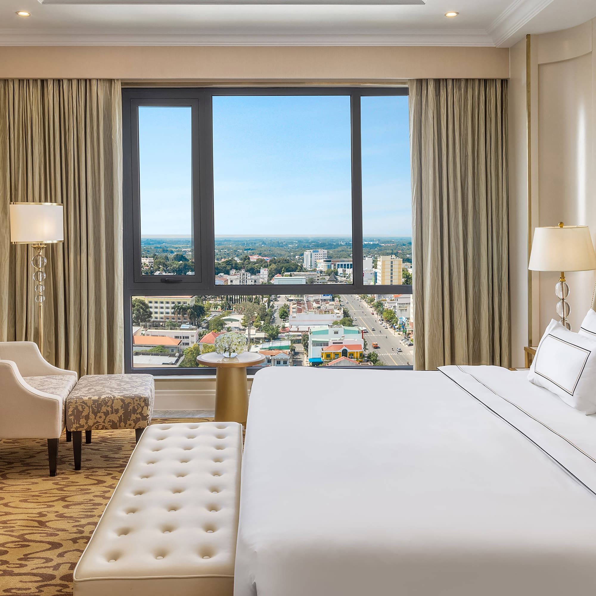 a bedroom with a large window and a large bed