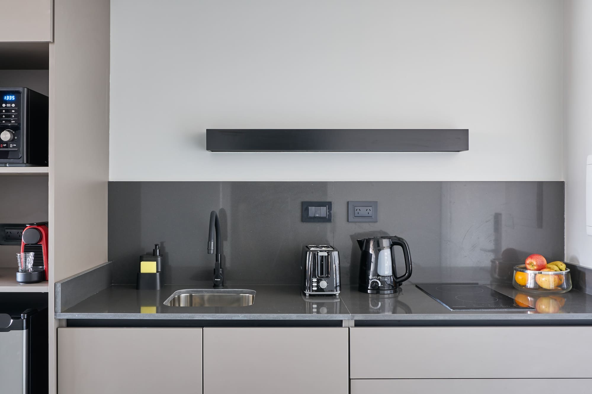 a kitchen with a microwave and coffee maker