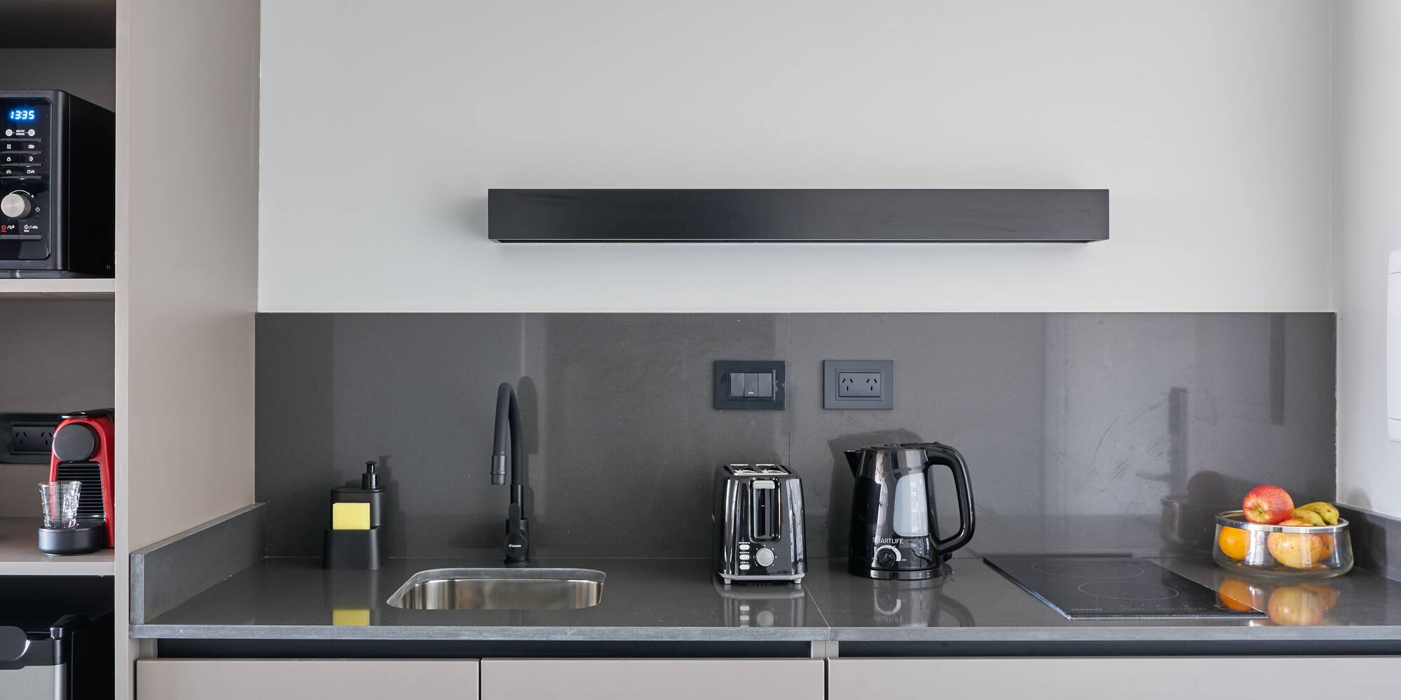 a kitchen with a microwave and coffee maker