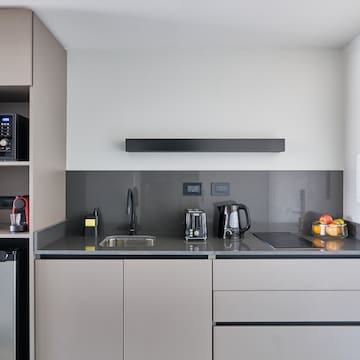 a kitchen with a microwave and coffee maker