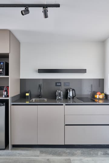 a kitchen with a microwave and coffee maker