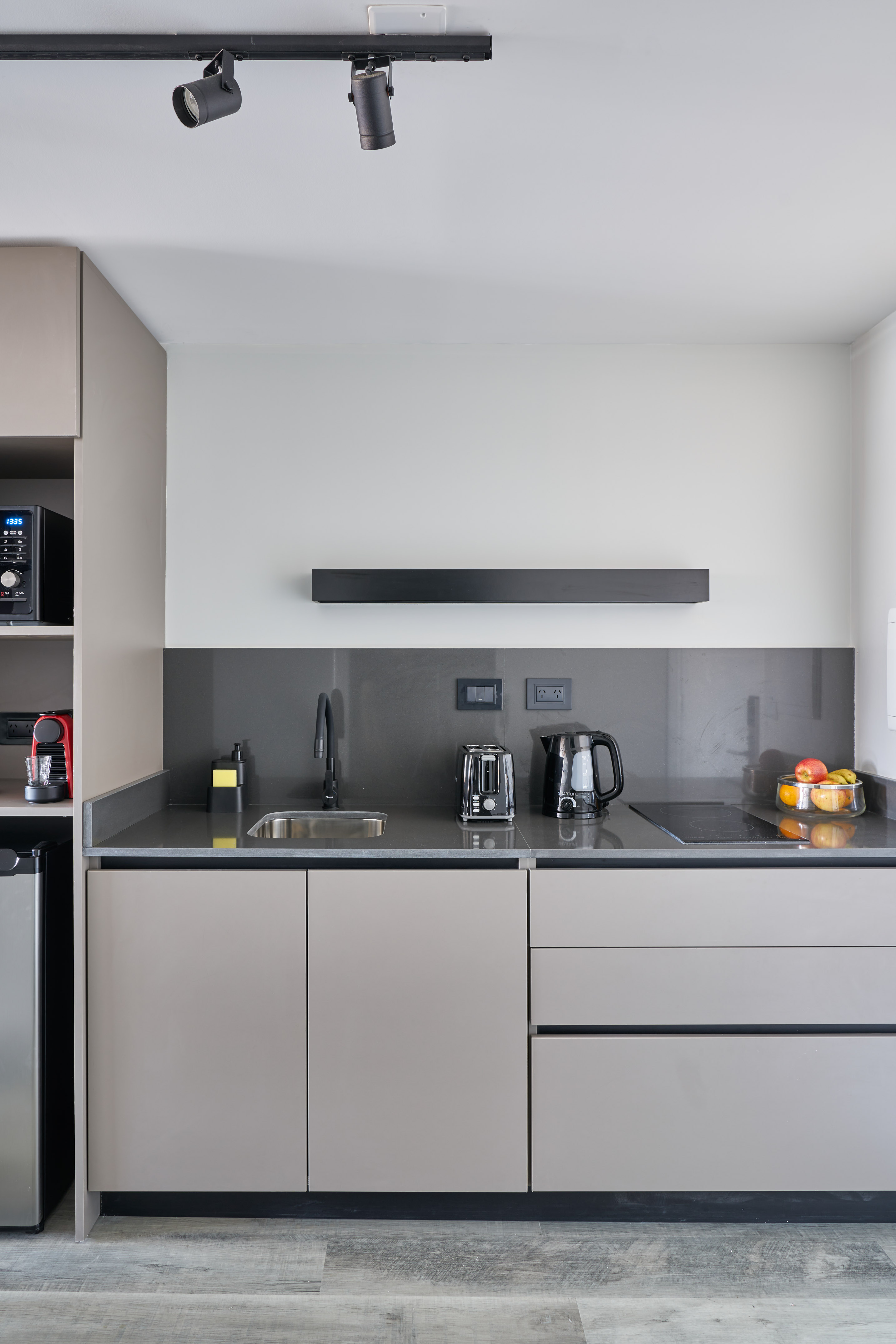 a kitchen with a microwave and coffee maker