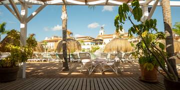 a patio area with chairs and trees