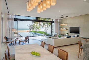 a living room with a pool and a table