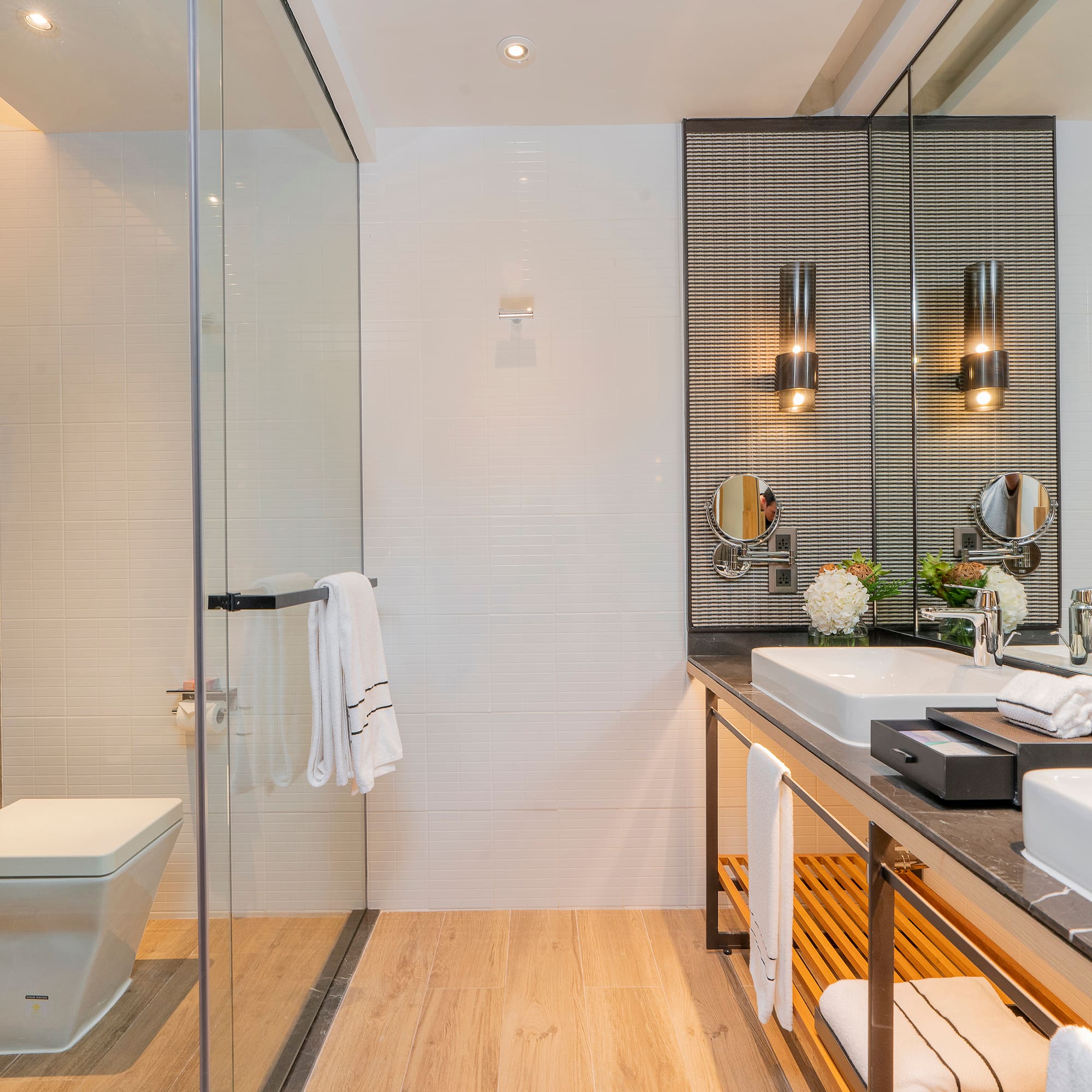 a bathroom with a glass shower and sink