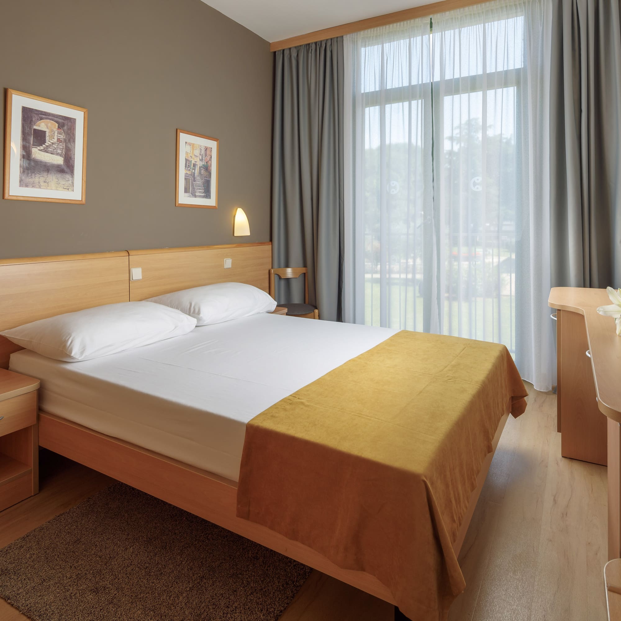 a bedroom with a bed and a desk