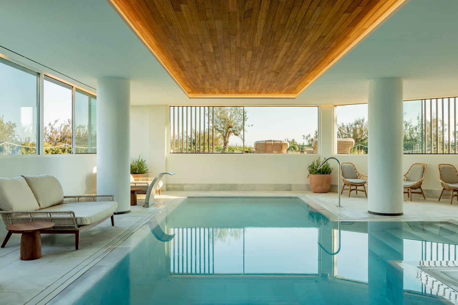 a indoor pool with a wooden ceiling and a wood ceiling