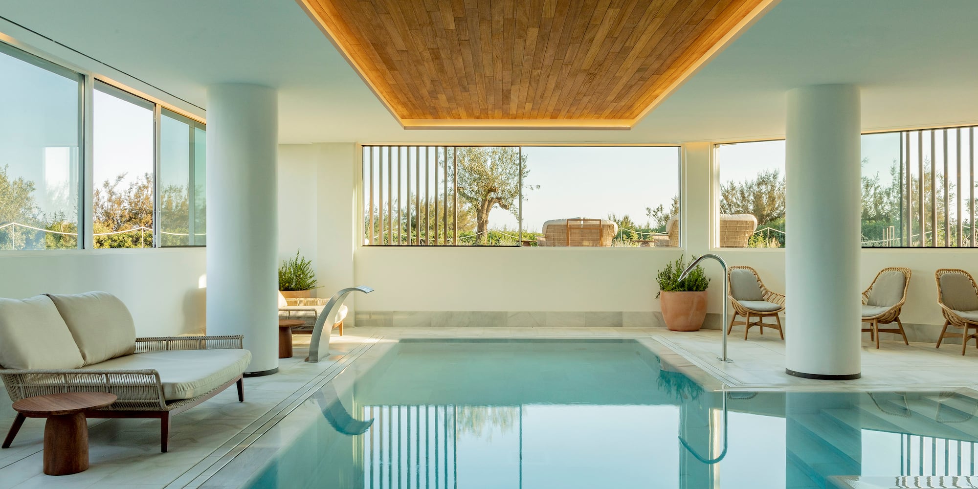 a indoor pool with a wooden ceiling and a wood ceiling