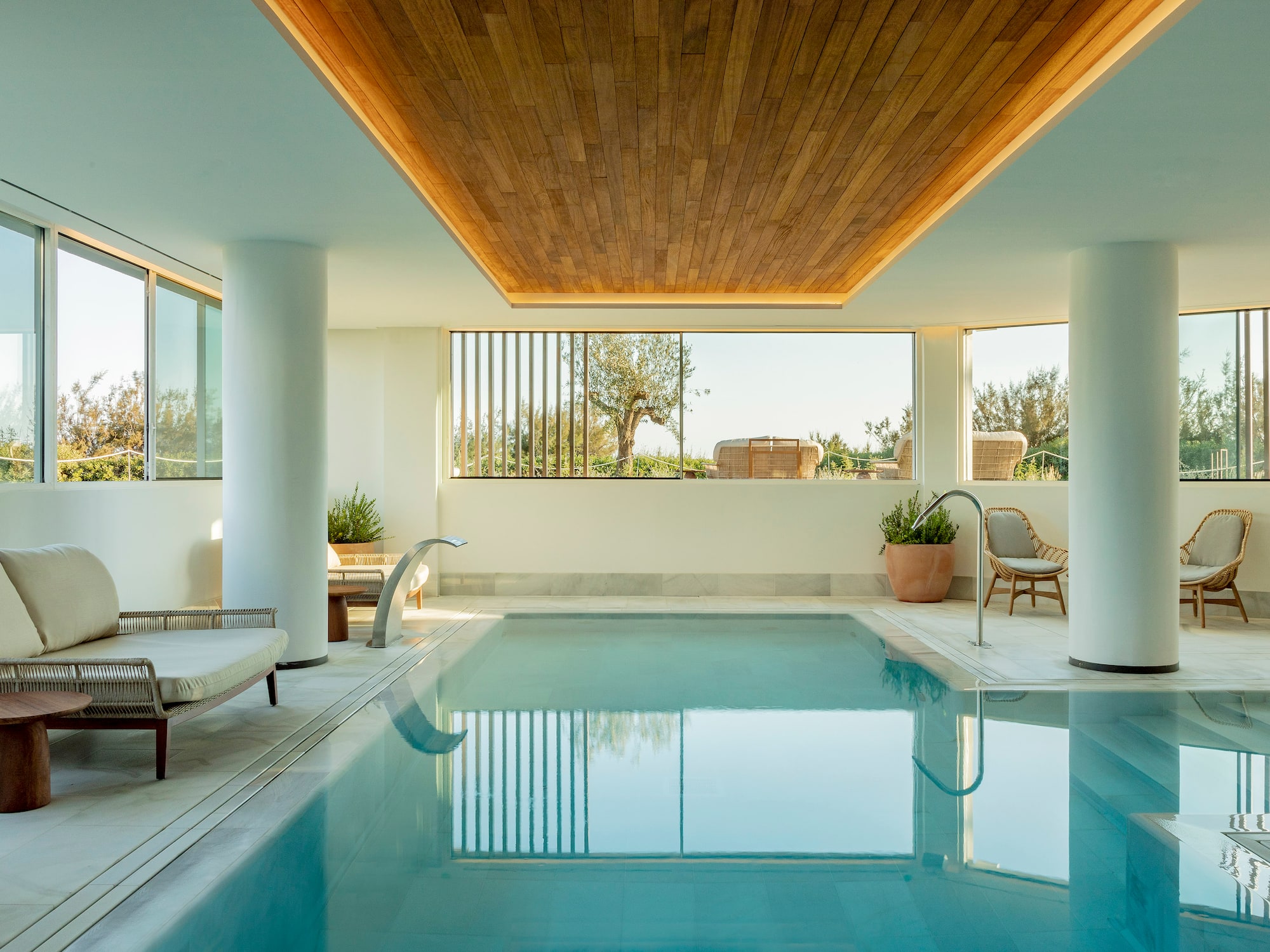 a indoor pool with a wooden ceiling and a wood ceiling