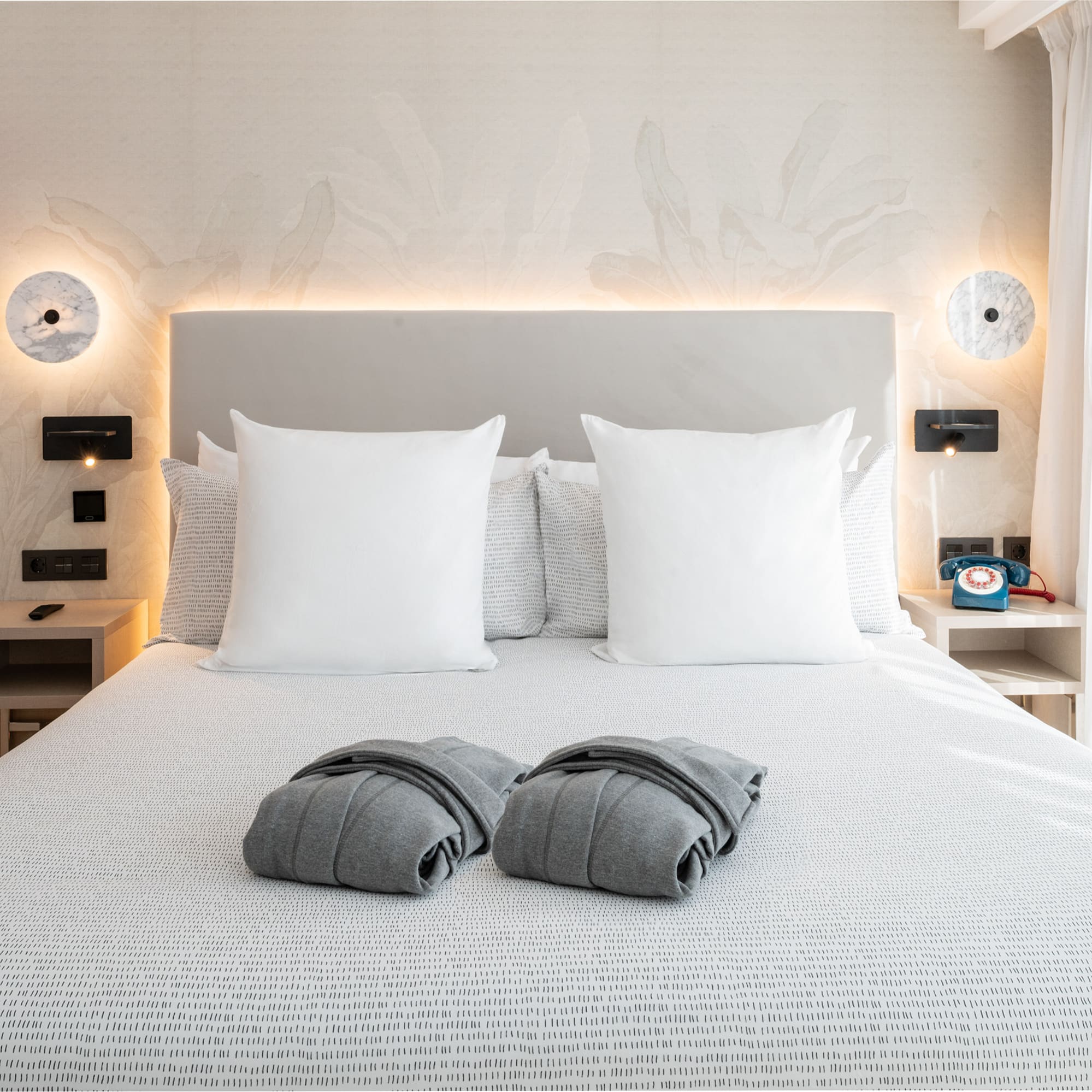 a bed with pillows and blankets on it