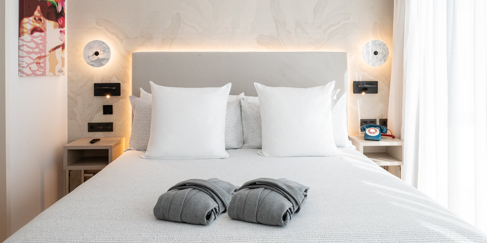 a bed with pillows and blankets on it