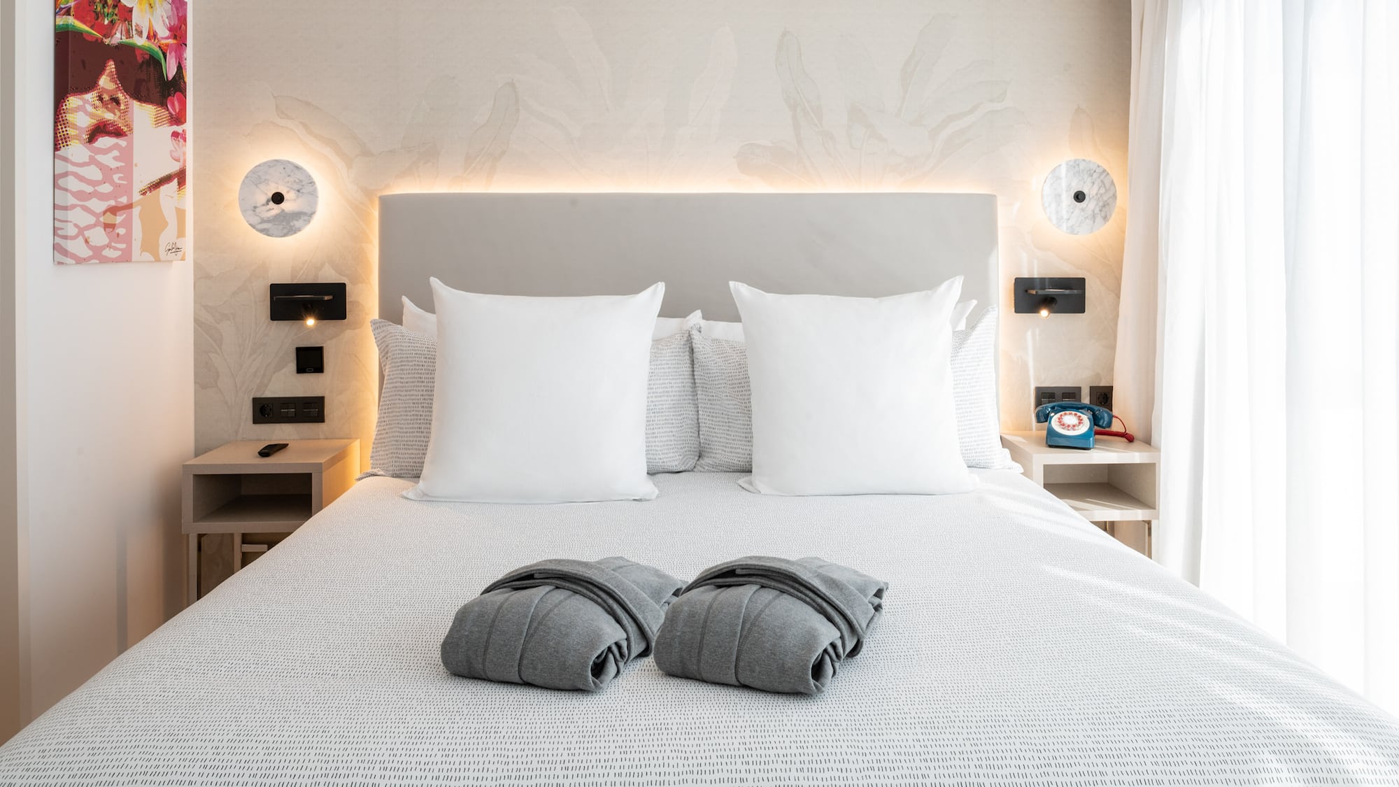 a bed with pillows and blankets on it