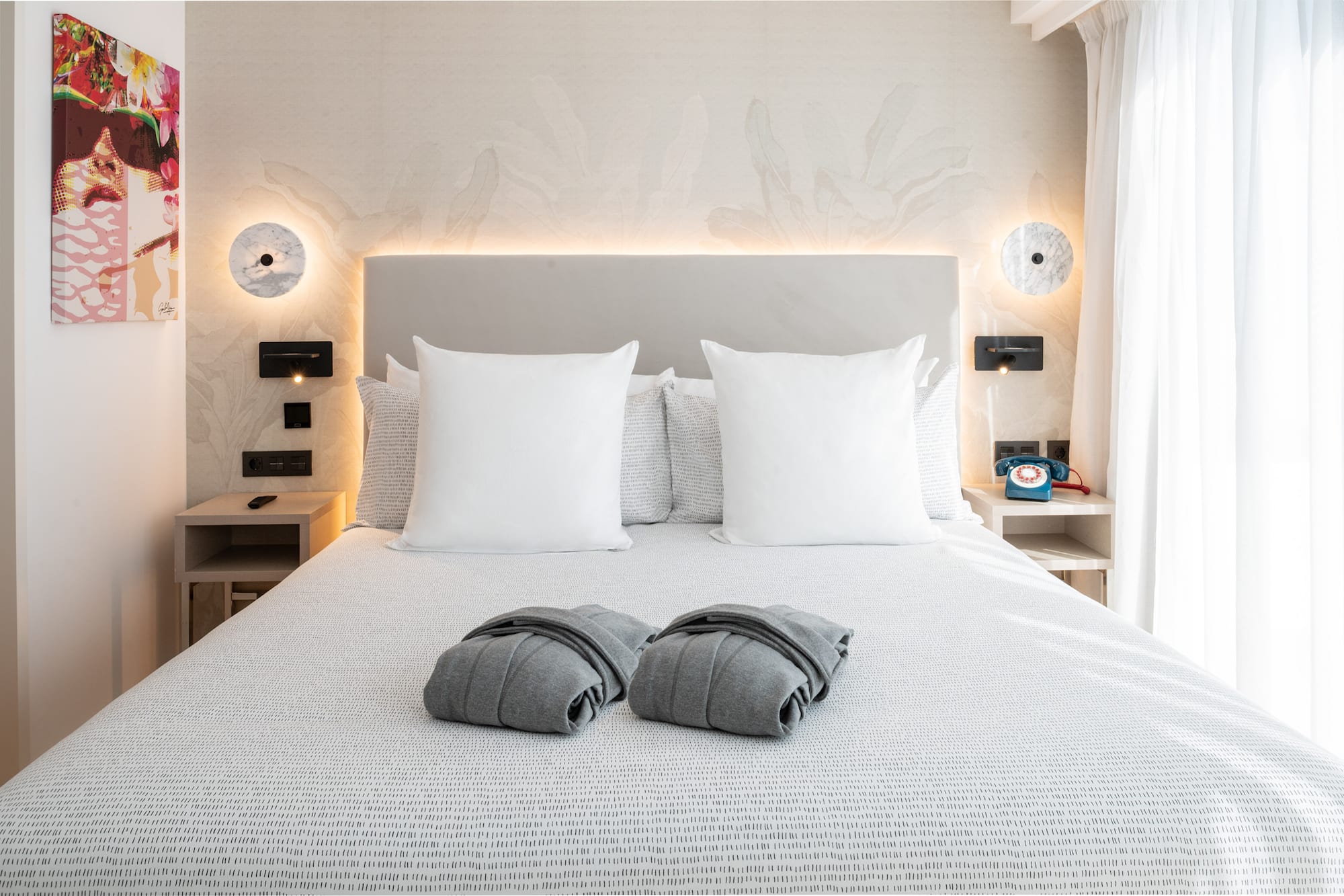 a bed with pillows and blankets on it