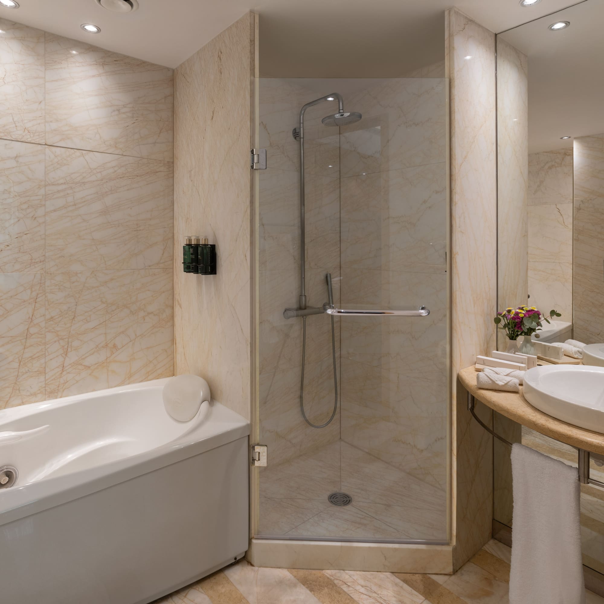 Luxurious marble bathroom with jacuzzi tub, walk-in shower, and elegant vanity.