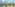 Tropical luxury resort with lagoon pools, palm trees, hotel buildings, ocean.