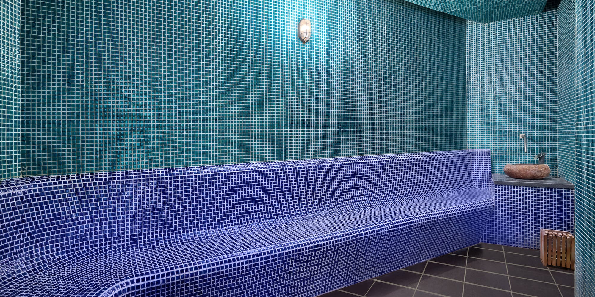 a blue tiled bench in a room