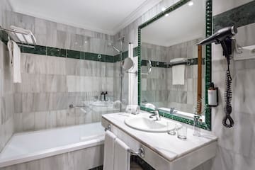 a bathroom with a mirror and a bathtub