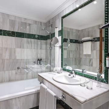 a bathroom with a mirror and a bathtub