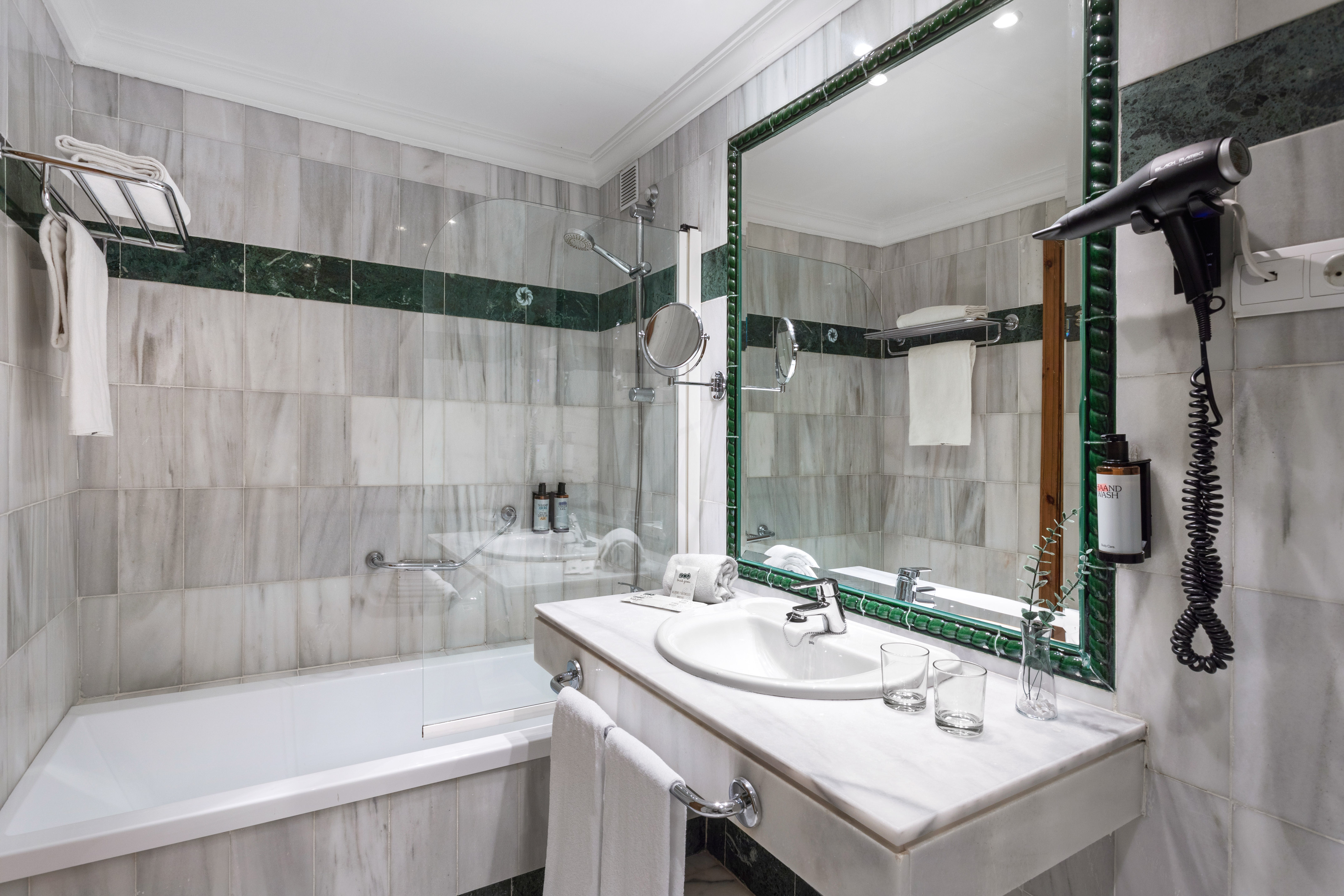 a bathroom with a mirror and a bathtub