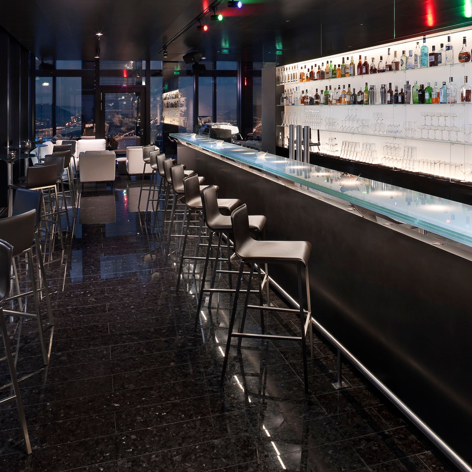 a bar with a row of chairs and a counter