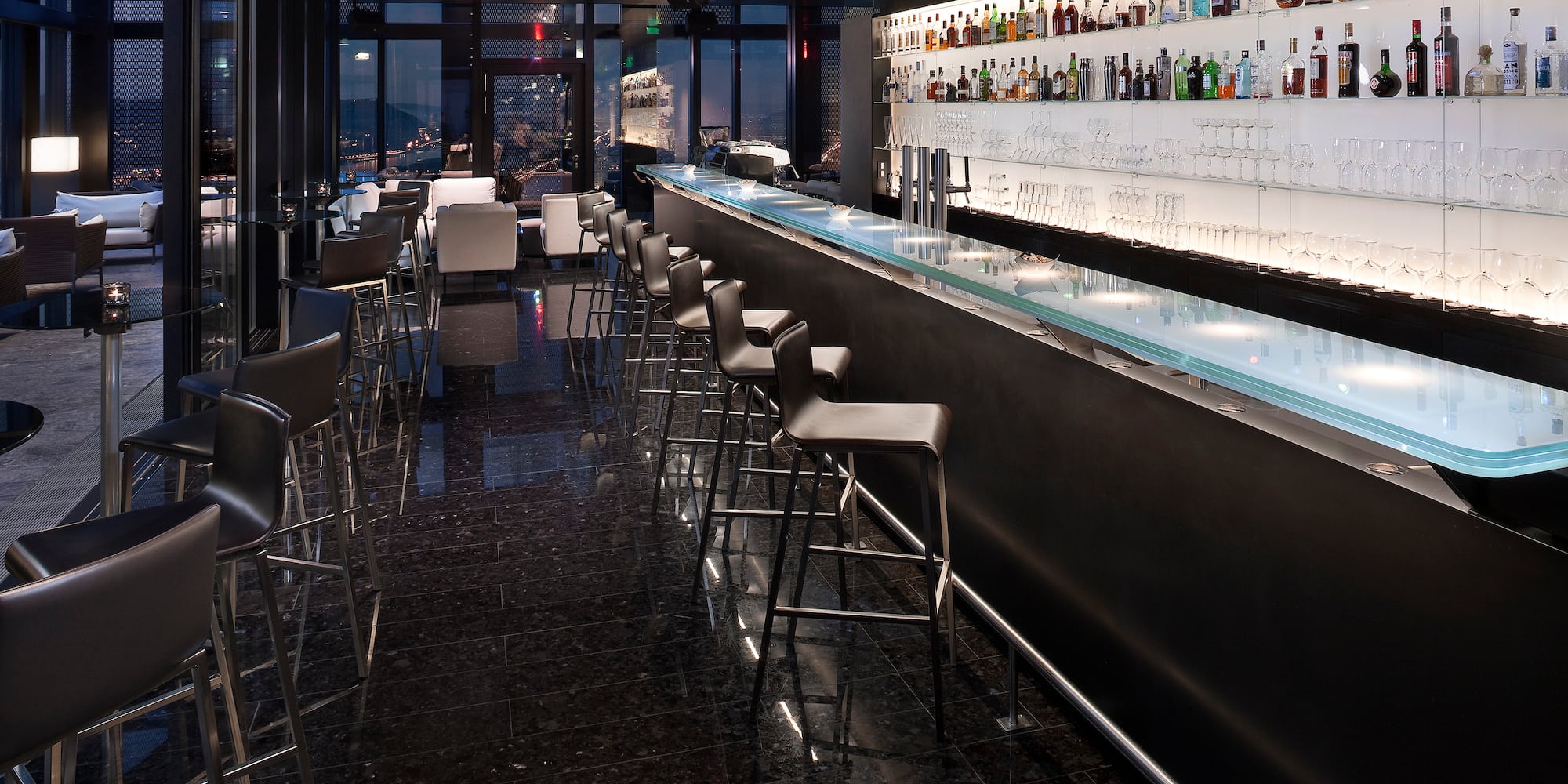 a bar with a row of chairs and a counter