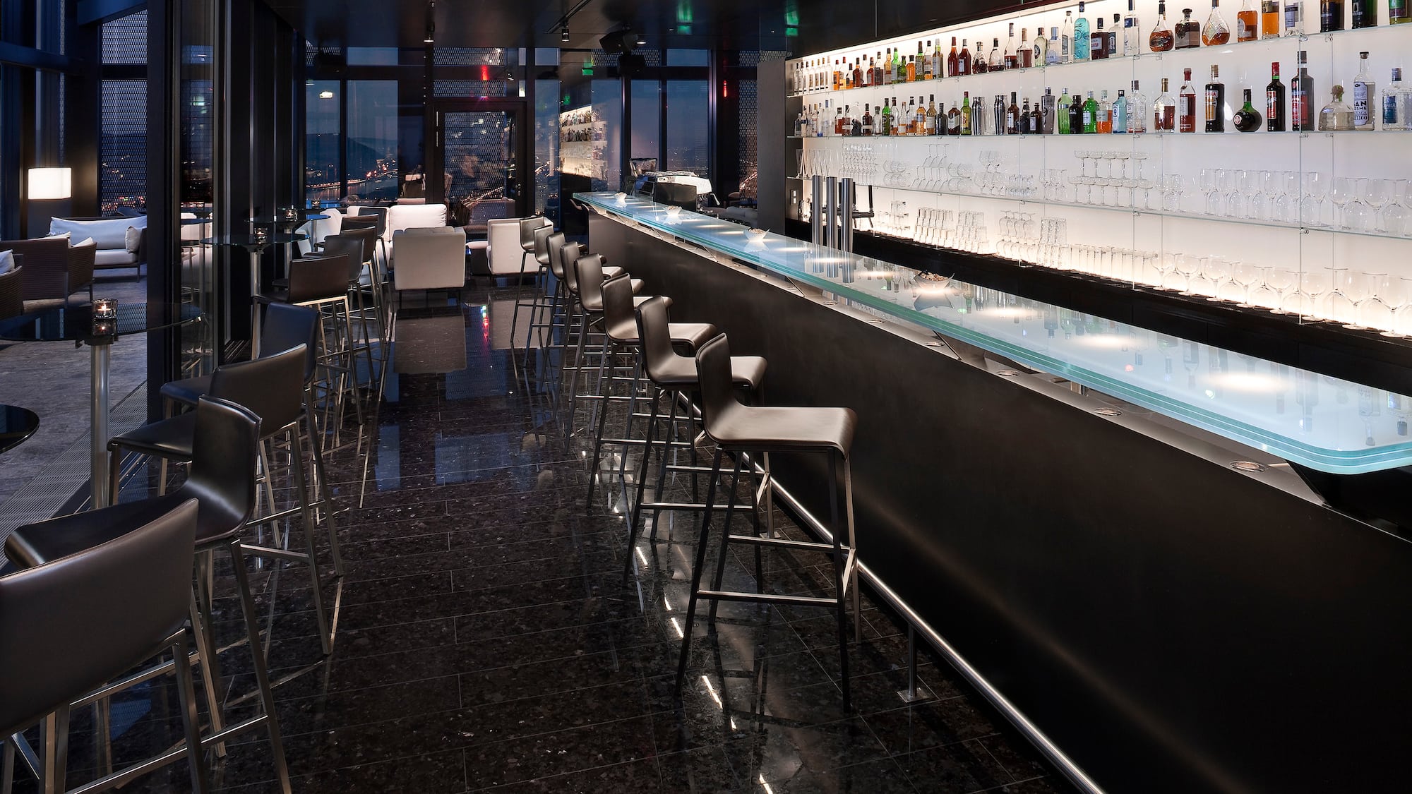 a bar with a row of chairs and a counter