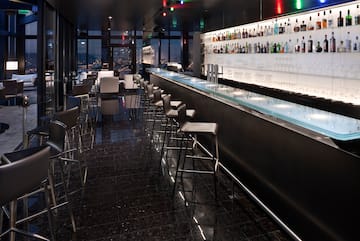 a bar with a row of chairs and a counter