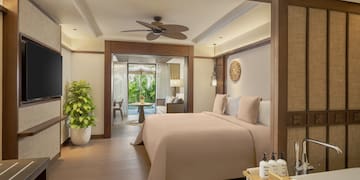 a bedroom with a television and a bed