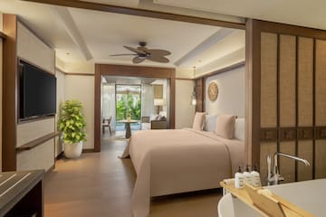 a bedroom with a television and a bed