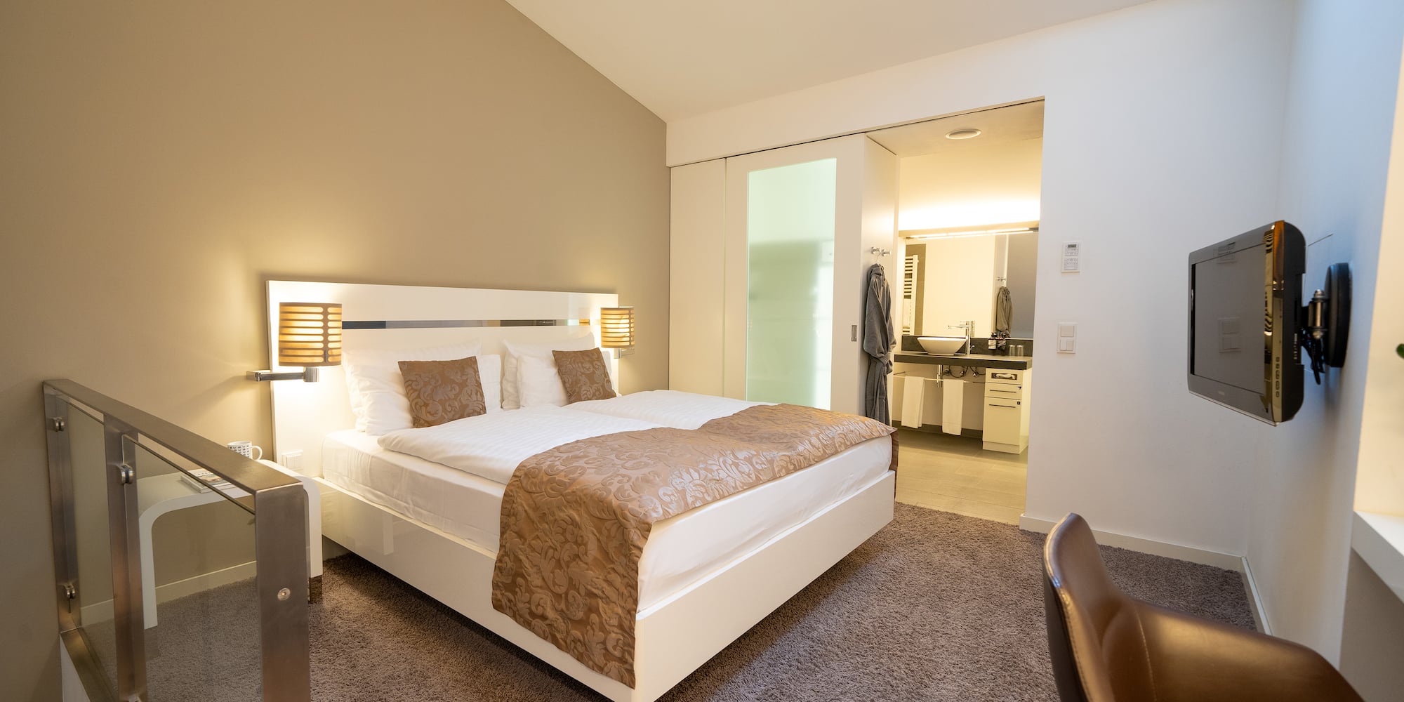 a bedroom with a bed and a glass door