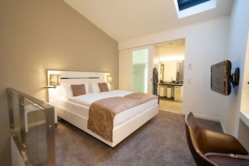 a bedroom with a bed and a glass door