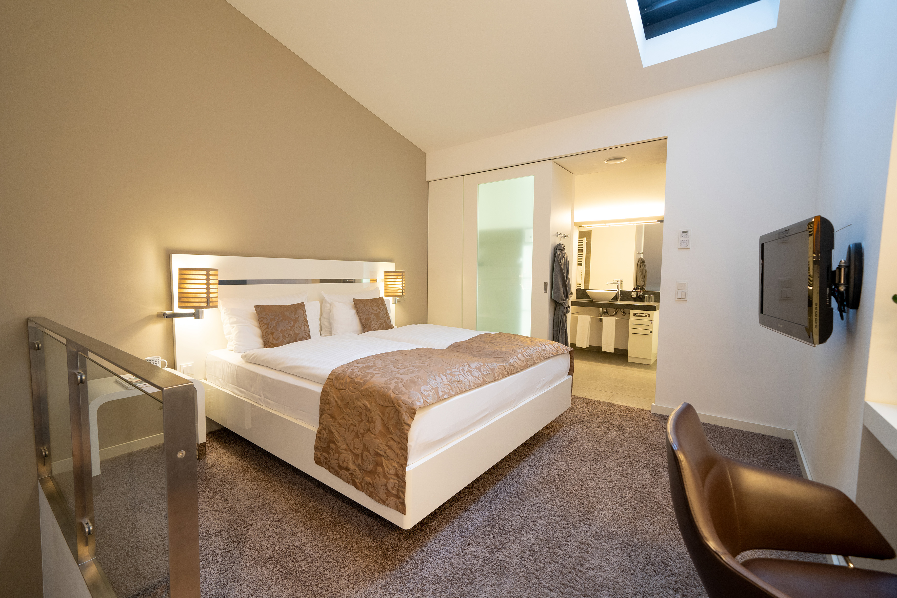 a bedroom with a bed and a glass door