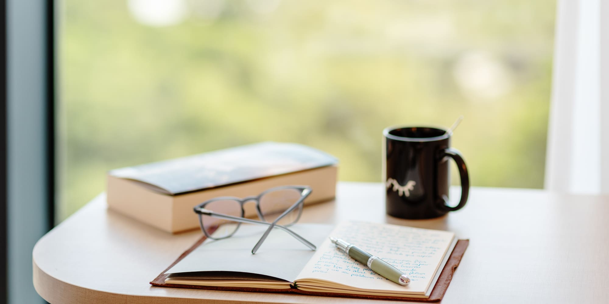 a book and pen on a table