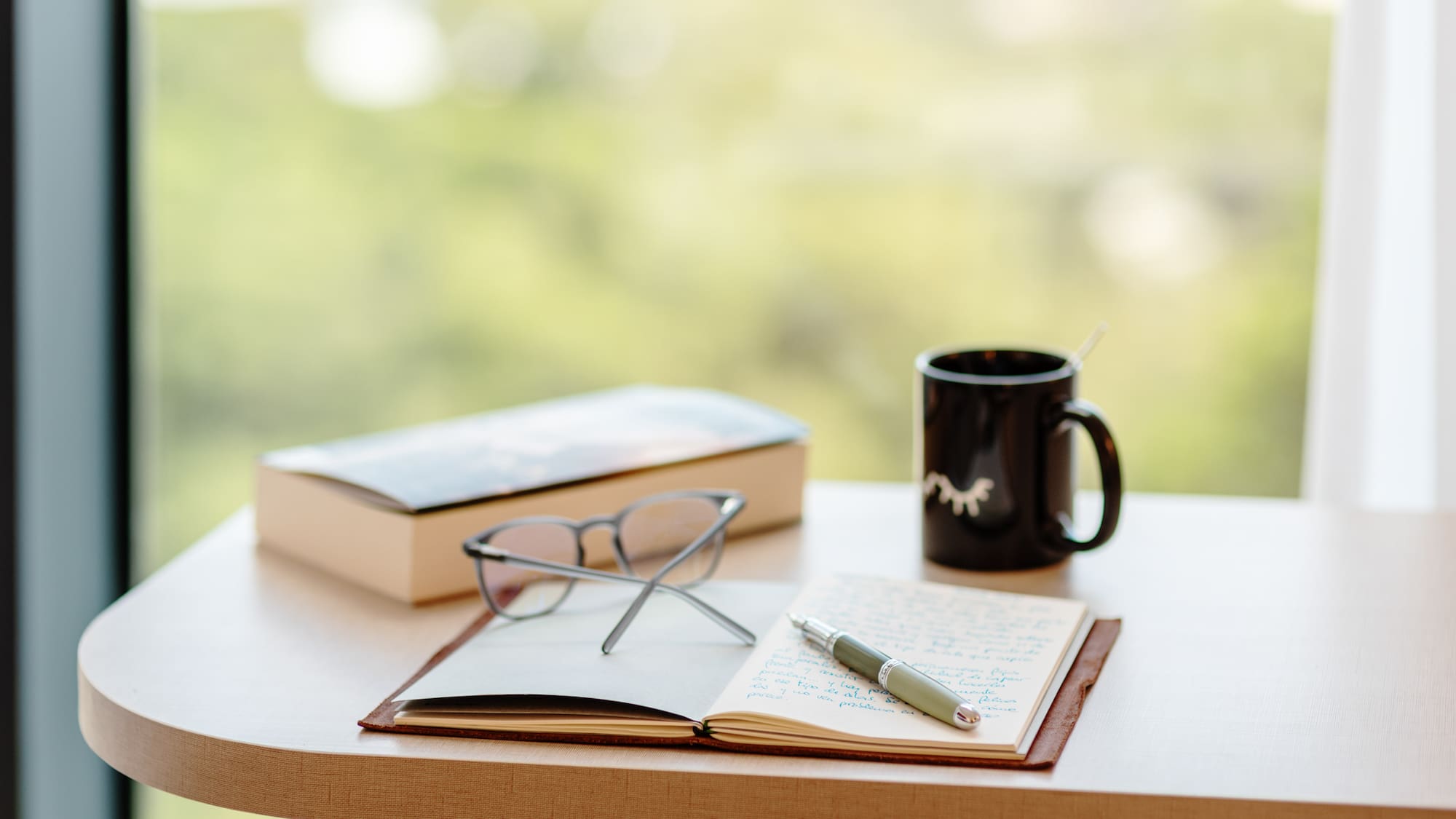 a book and pen on a table