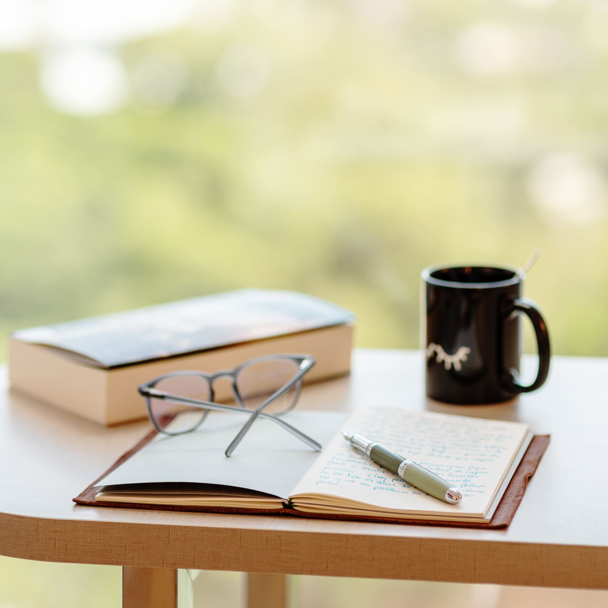 a book and pen on a table