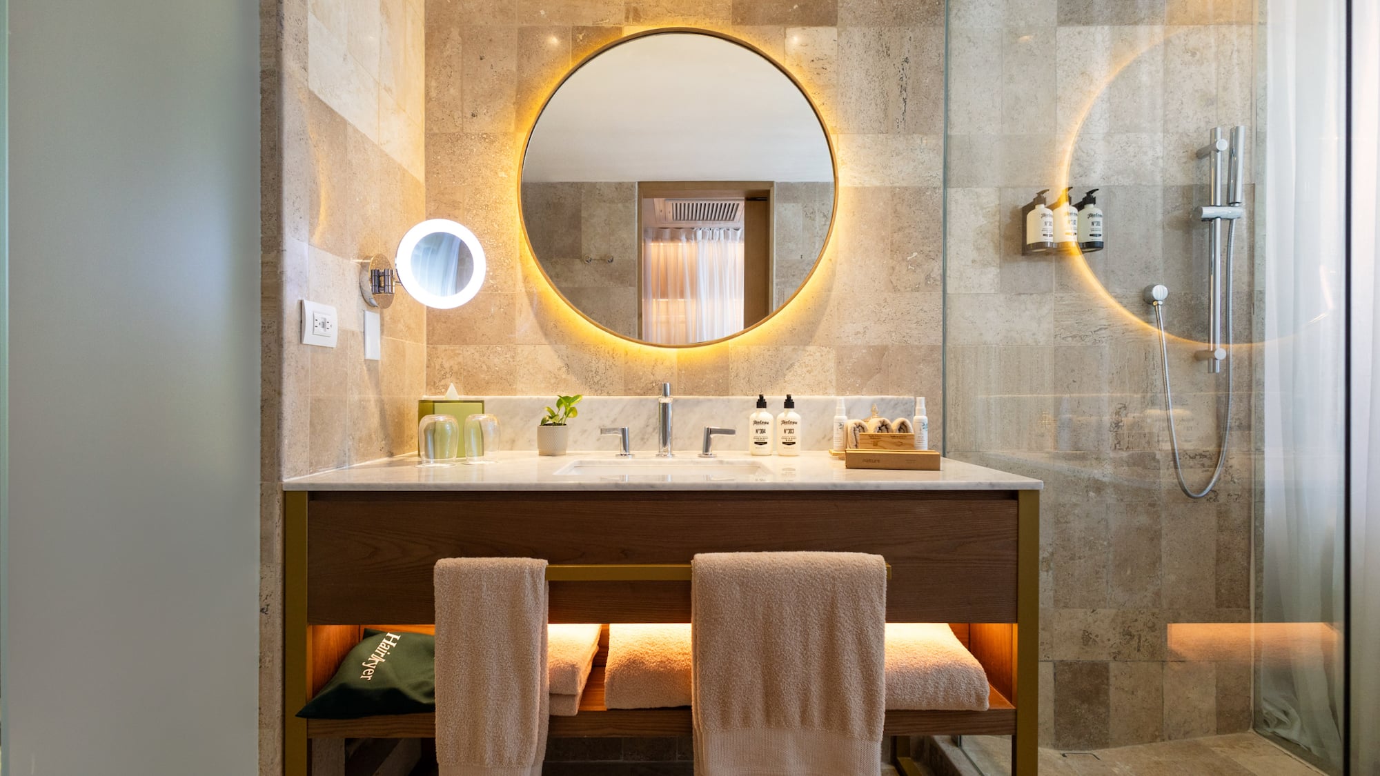 a bathroom with a round mirror and a sink