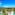 Luxury tropical resort with pools, palm trees, modern architecture, and ocean.