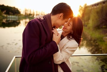 a man and woman hugging and smiling