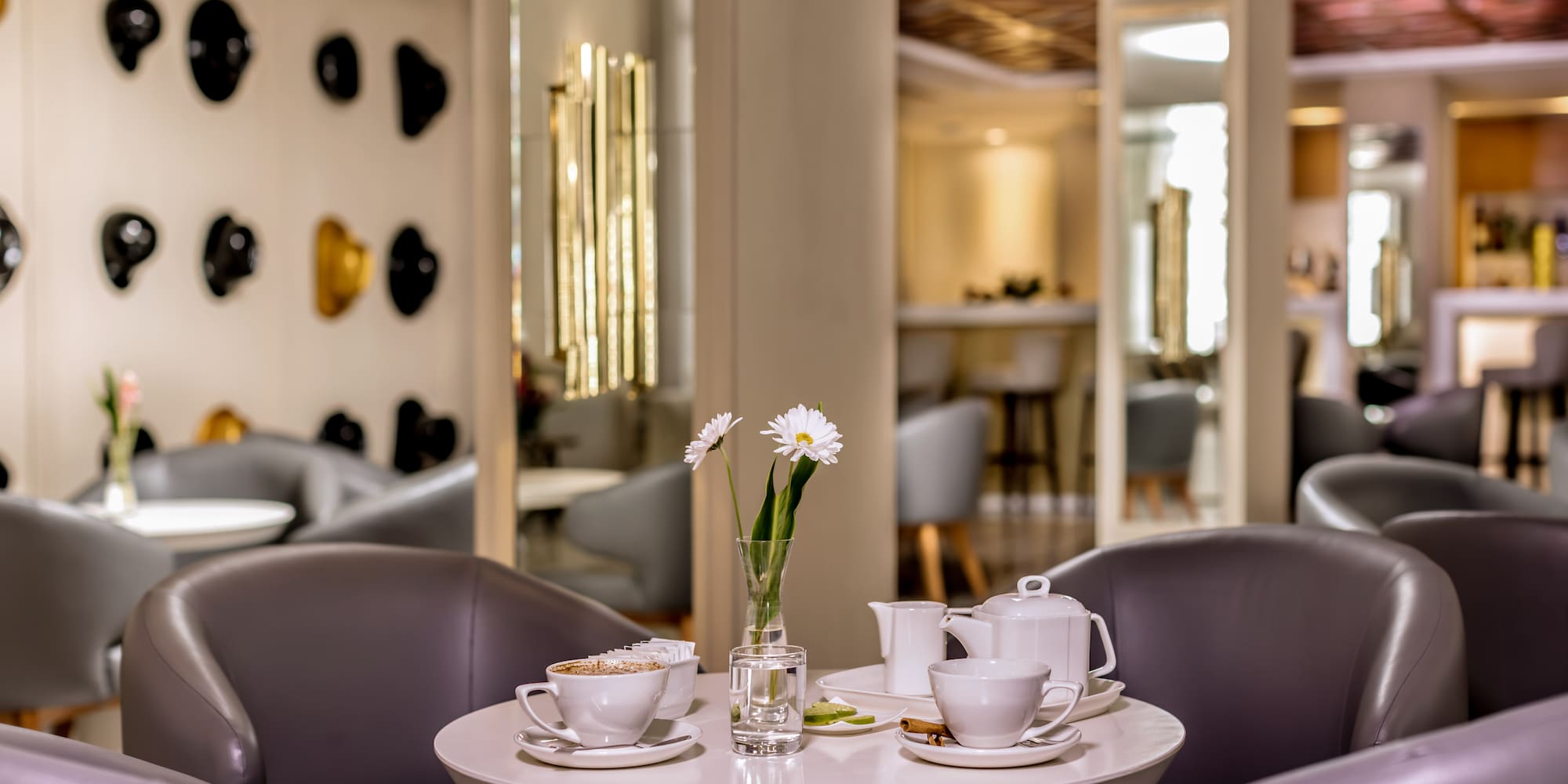 a table with white cups and saucers with flowers on it