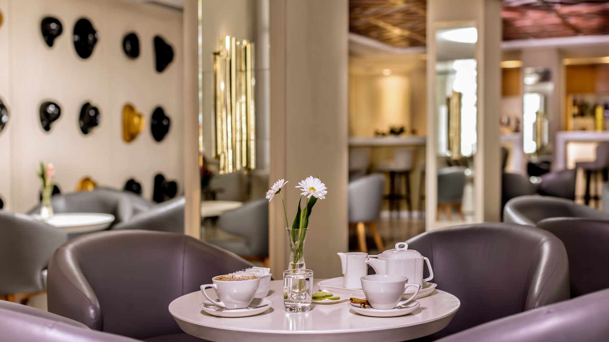 a table with white cups and saucers with flowers on it