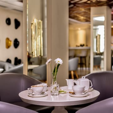 a table with white cups and saucers with flowers on it