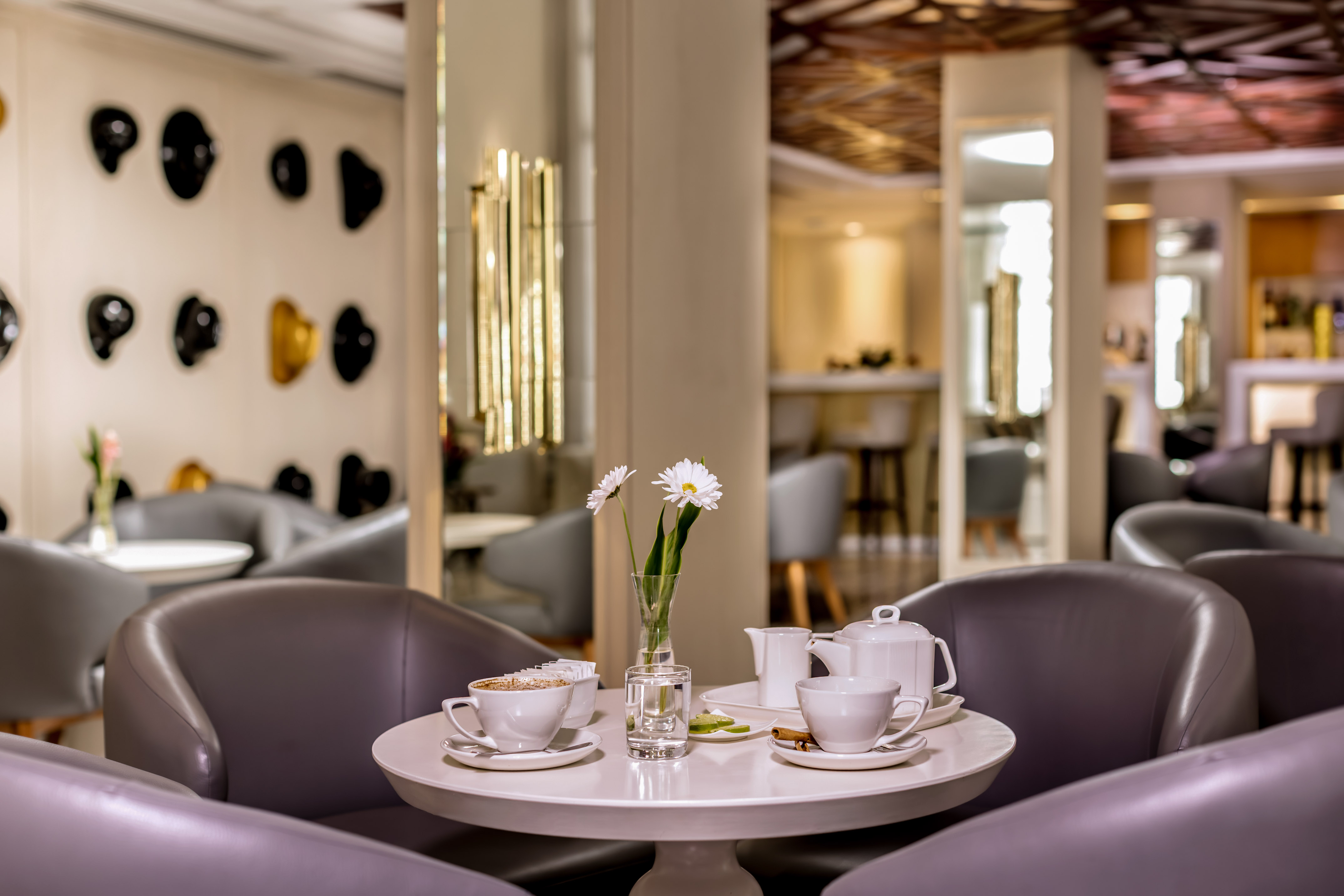a table with white cups and saucers with flowers on it