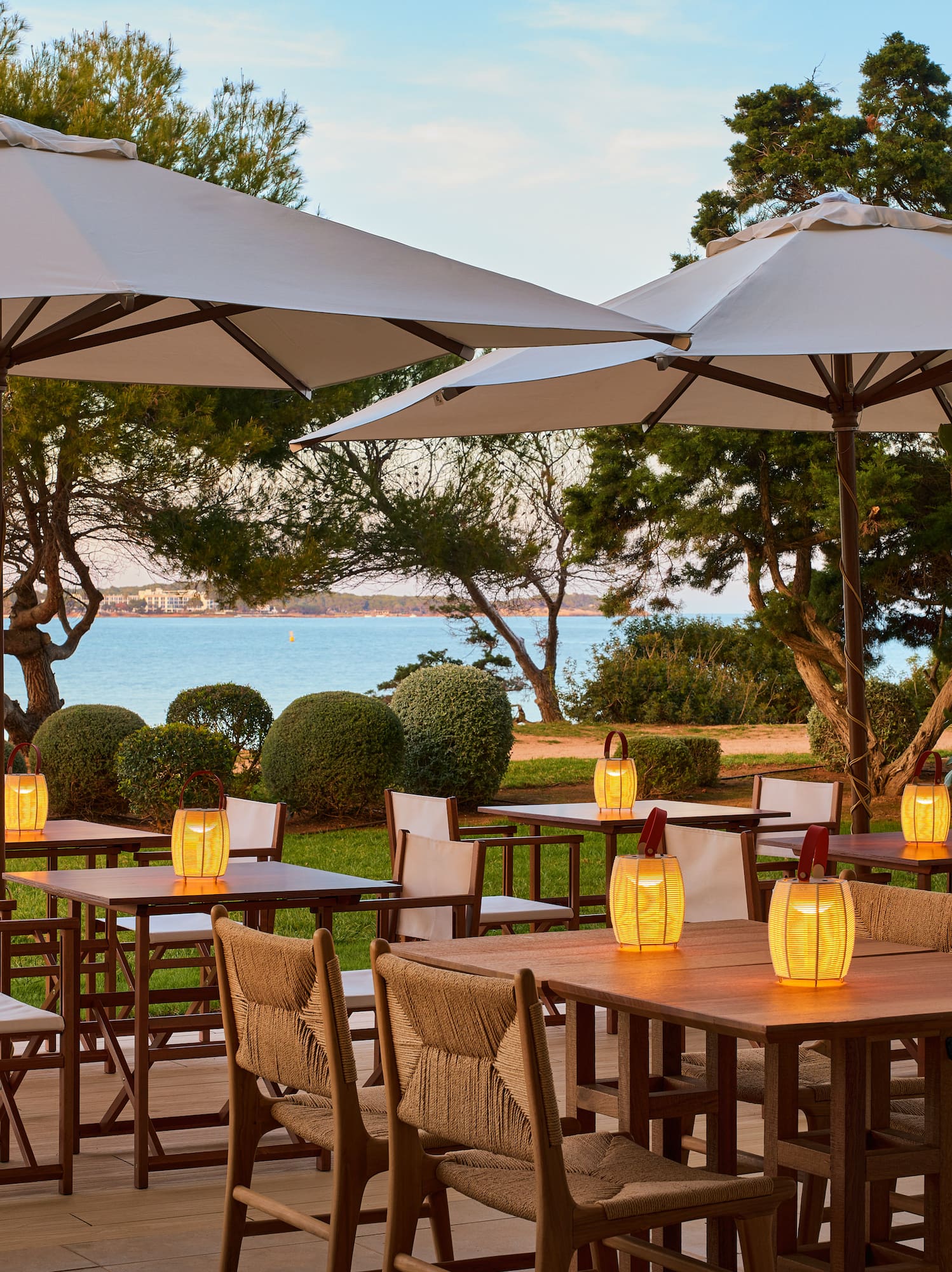 a table and chairs under umbrellas