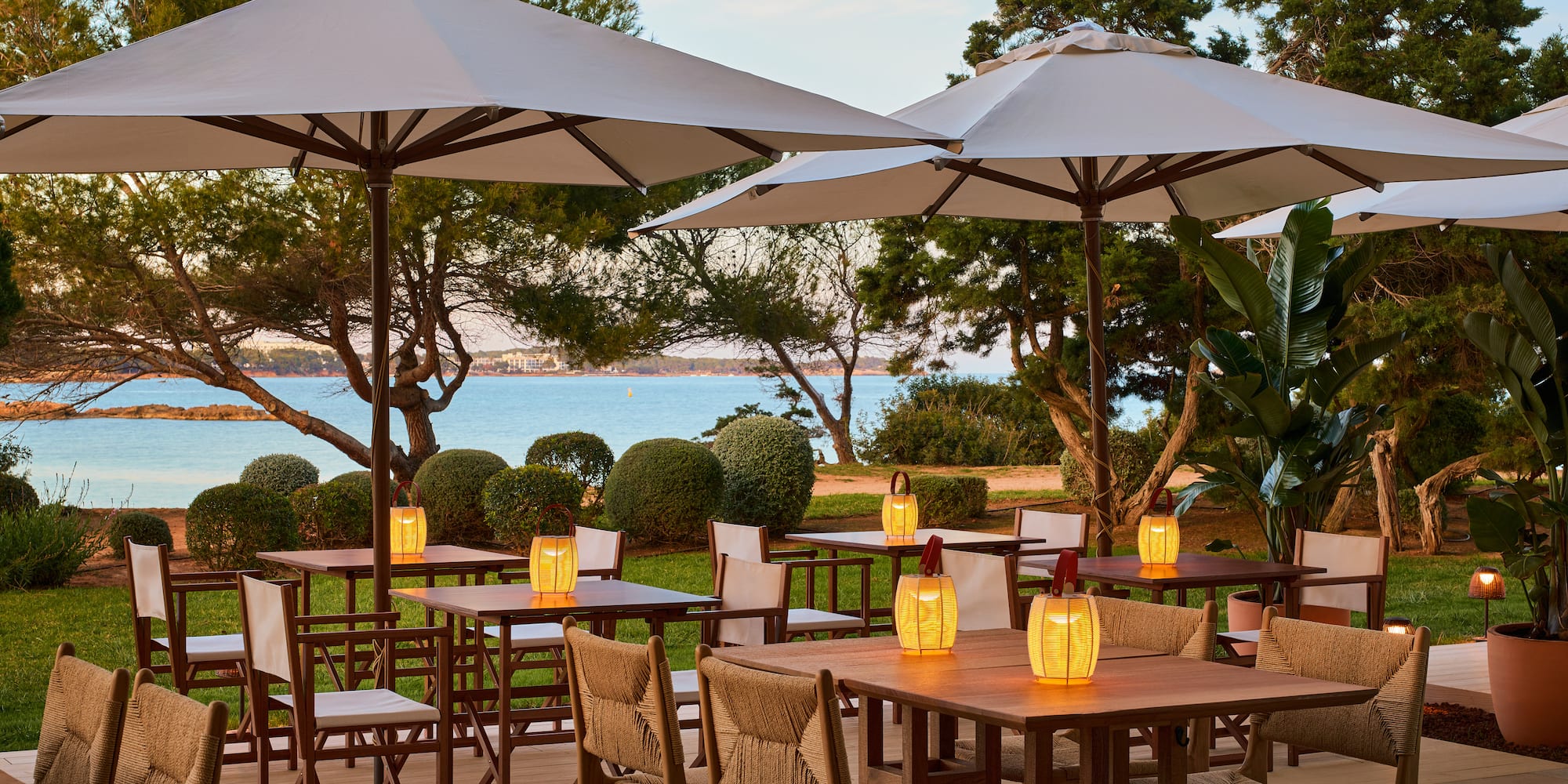 a table and chairs under umbrellas